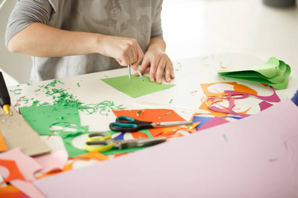 istock Woman using drawing compass to make paper stencils for her art and craft project 1172962113