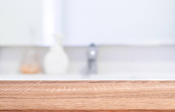 istock blurred inside of interior luxury modern bathroom background with modern brown wood tabletop for show,ads,design product on display concept 1172962395