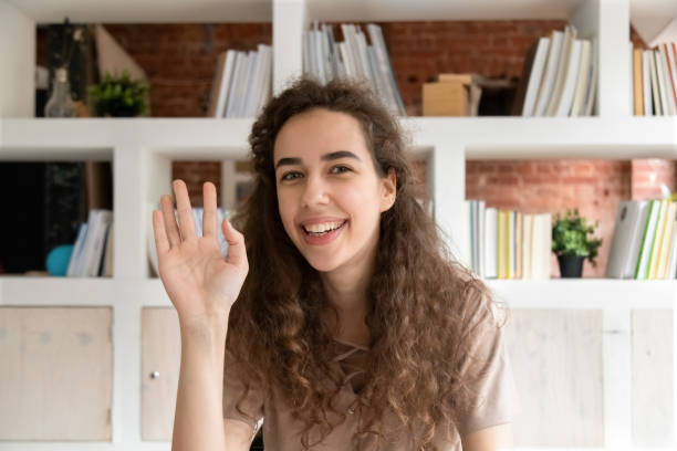istock Head shot portrait smiling woman waving hand, using webcam 1172962490