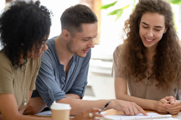 istock Smiling diverse students or employees working on project together 1172962599