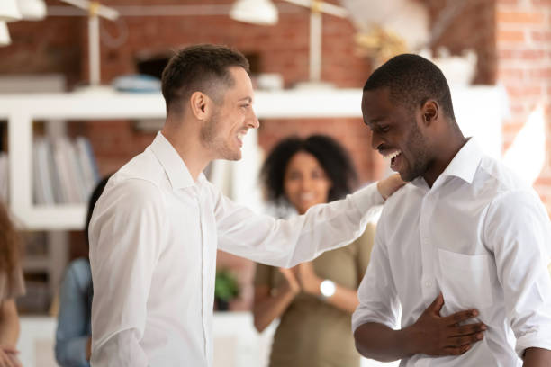 istock Executive manager congratulating African American employee at meeting 1172962625