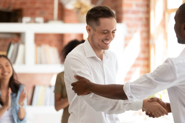istock Employee getting promoted, handshaking with African American boss 1172962637