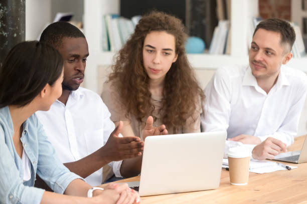 istock African American businessman mentor teaching interns, using laptop 1172962686
