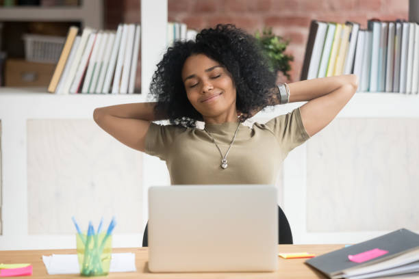 calm african american businesswoman relaxing in comfortable office chair - african descent american culture exercising women imagens e fotografias de stock