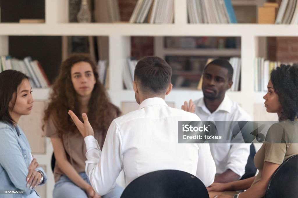 Person Sharing A Problem Rear View Man Sharing Problems With Diverse Group At Therapy Stock ...