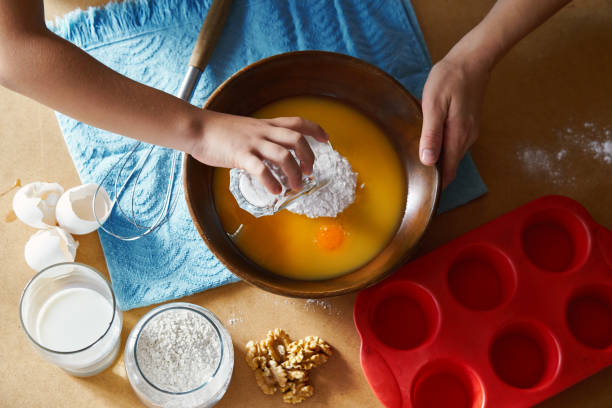 istock Mother and children preparing cake together 1172963822