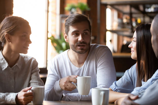 istock Diverse group of best friends sitting in cafe and chatting 1172964132