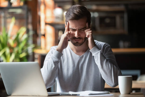 istock Man touching with fingers forehead thinking or suffering from headache 1172964256