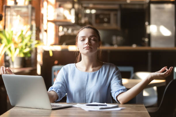 istock Young woman sitting at table in cafe relaxing do meditation 1172964269