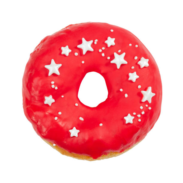 istock Donut with red icing and sprinkles isolated on white 1172965271