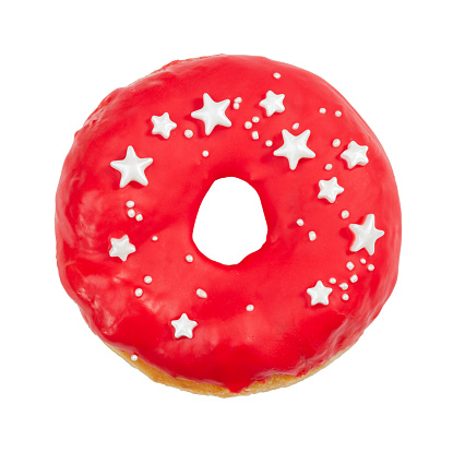 Donut with red icing and sprinkles isolated on white background.