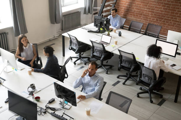 istock Top view of diverse workers busy working in shared office 1172966452