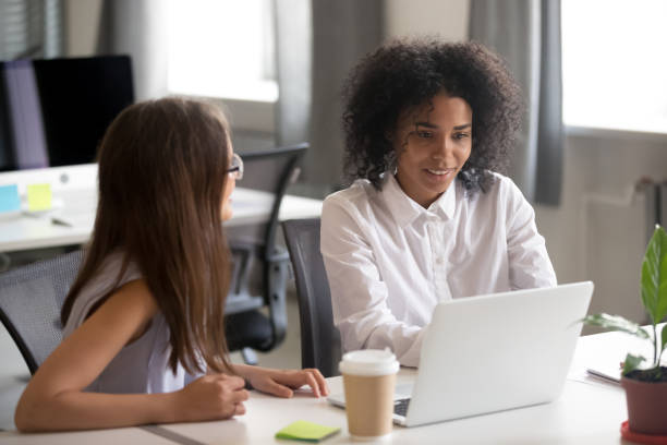 istock Female colleagues discuss ideas working at laptop together 1172966495