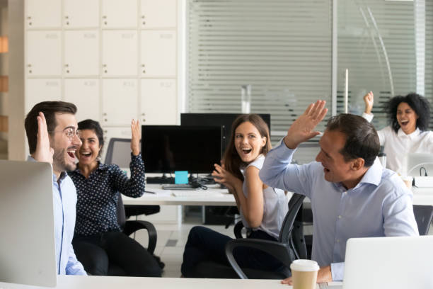 istock Excited coworkers celebrate shared business win in office 1172966559