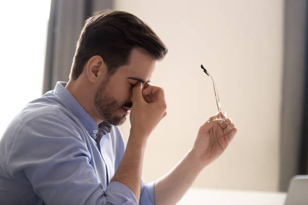 istock Tired man massage eyes suffering from headache 1172966669