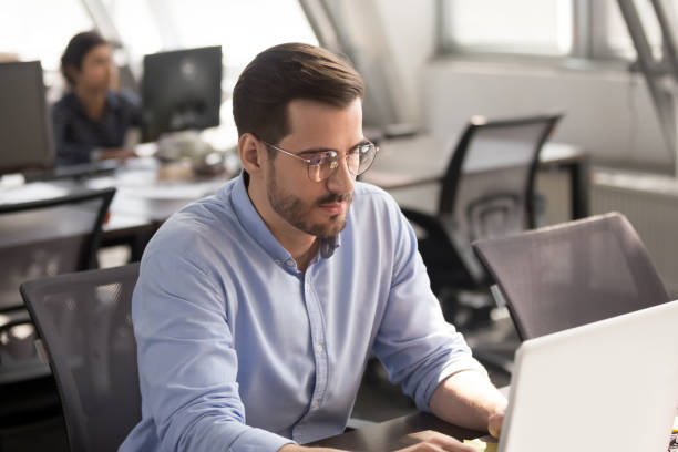 istock Focused male employee busy working on laptop 1172966808