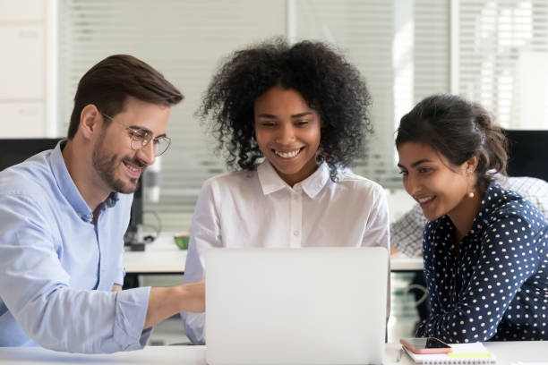 istock Multiracial happy colleagues talk working together on laptop 1172966833