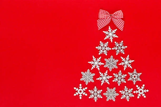 istock White snow flake decoration on red background. Flat lay, top view 1172969706