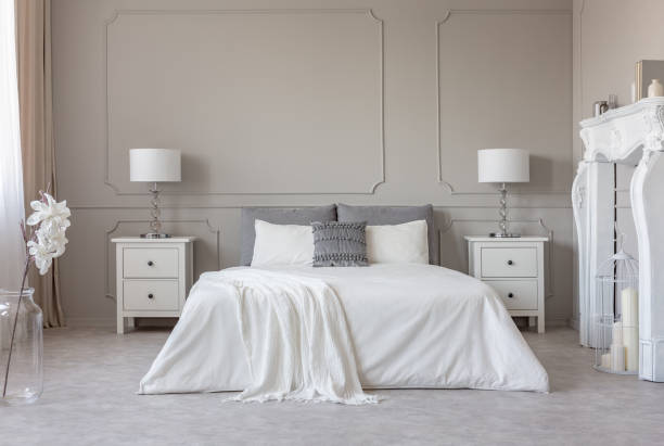 istock New york style bedroom interior with symmetric design, copy space on empty grey wall 1172970013