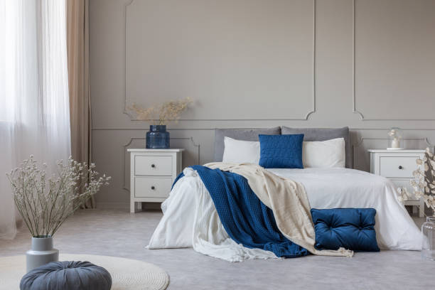 istock Chic feminine bedroom interior in trendy apartment, copy space on empty wall 1172970015