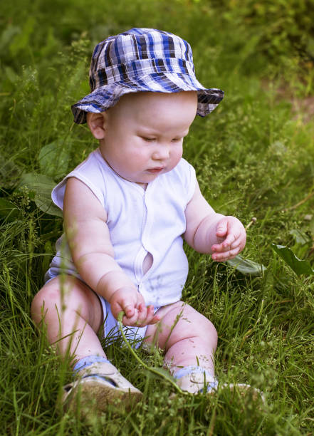 istock Baby sitting on the grass 1172970724