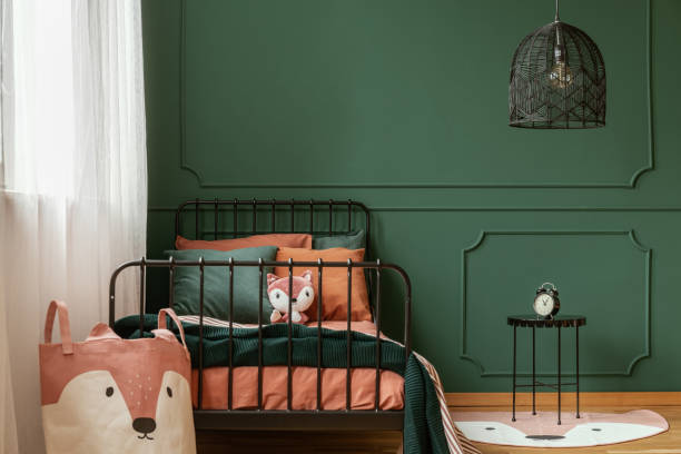 istock Copy space on empty dark green wall of trendy bedroom interior 1172971305