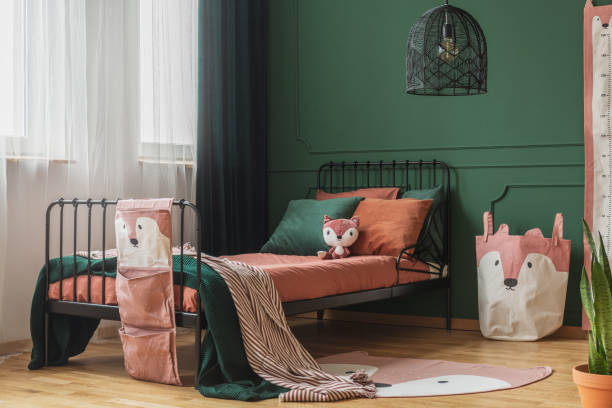 istock Fox theme in cute bedroom interior with green wall and orange bedding 1172971311
