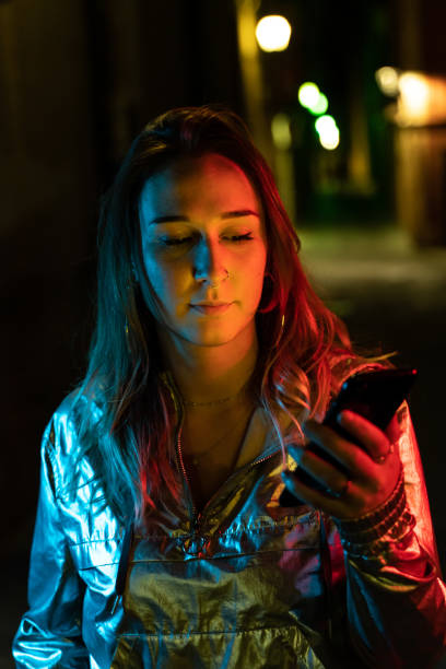 istock Young woman using smartphone at night 1172972614