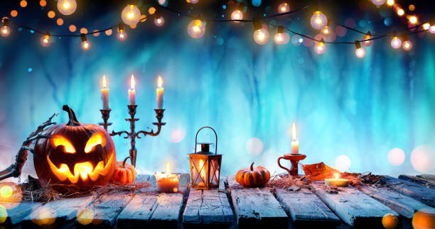 istock Smiling Pumpkin And Candelabrum On Table In Spooky Forest 1172974163