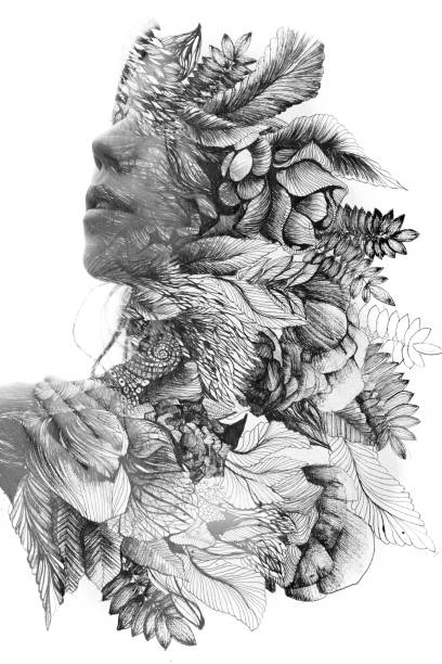 Paintography. Double exposure profile of a young natural beauty, with face and hair combined with hand drawn leaves and flowers dissolving into the background, black and white stock photo