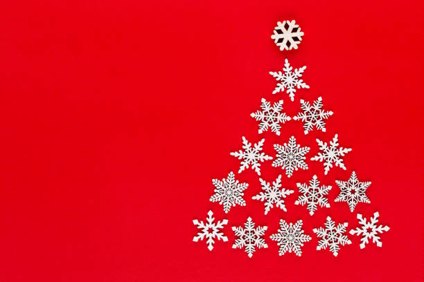 istock White snow flake decoration on red background. Flat lay, top view 1172974988