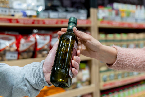istock Unrecognizable customer handing an olive bottle oil to partner 1172975622
