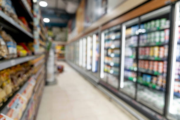 Unfocused shot of aisle at a supermarket Unfocused shot of aisle at a supermarket - No people refrigerated section supermarket photos stock pictures, royalty-free photos & images