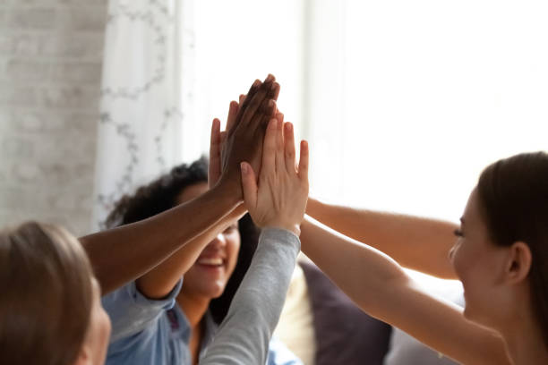 istock Close up diverse people giving high five. 1172977035