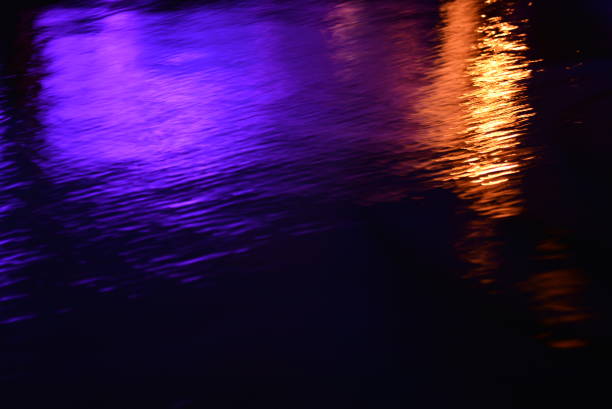 Glare and reflection of light on the water. Soft focus.