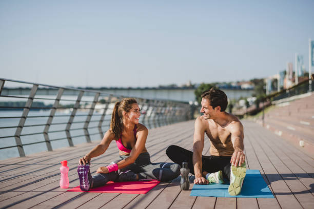 istock Young man and young woman exercising together 1172982026
