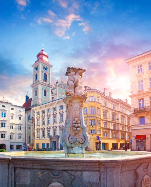 Fountain and Old Cathedral on the main square in Linz Fountain on the main square in Linz and Old Cathedral (Alter Dom) behind linz austria stock pictures, royalty-free photos & images