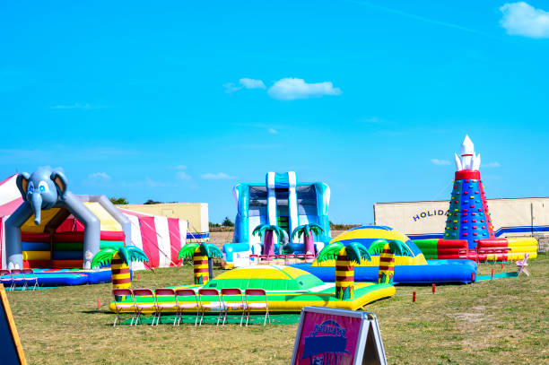 Playground with bouncy castles on a meadow to romp for children in the countryside of Berlin. Grossziethen, Germany - September 1, 2019: Playground with bouncy castles on a meadow to romp for children in the countryside of Berlin. party rental essentials stock pictures, royalty-free photos & images