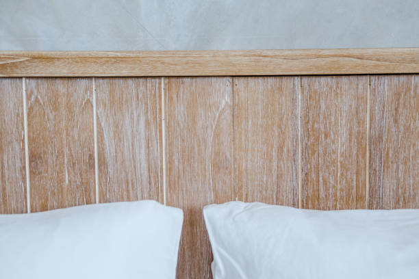 istock Wooden bedhead and gray concrete wall 1172988486