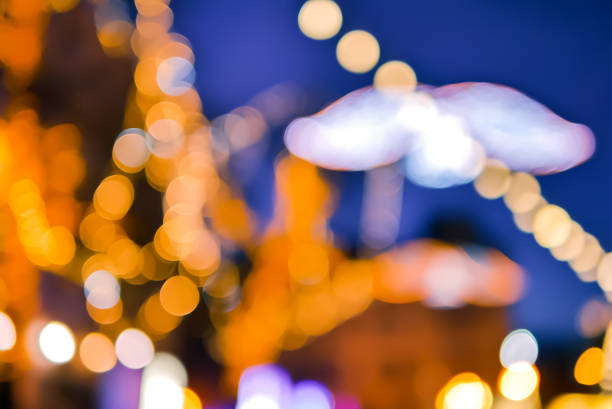 istock Blurred outdoor decorative Christmas lights and angel silhouette 1172988721