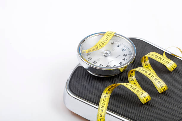 istock Slim concept with scale and measuring tape on white background top view 1172989478