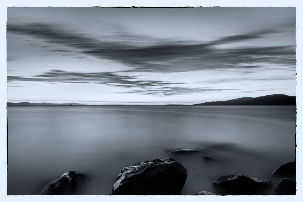 istock black and white image: smooth sunset glow view from Tower Beach, UBC, Vancouver, BC, Canada 1172994183