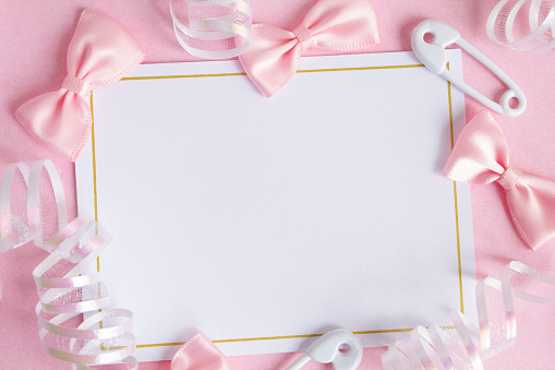 A blank card with copy space, surrounded by ribbons and pink bows.
