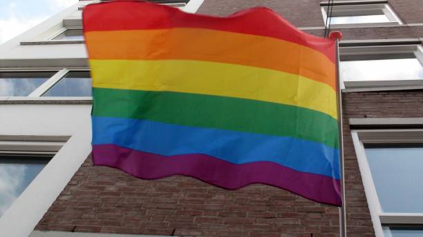 istock Rainbow Flag Hanging On Building View In The Netherlands Europe 1172996225
