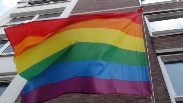 istock Rainbow Flag Hanging On Building Scenery In The Netherlands Europe 1172996231