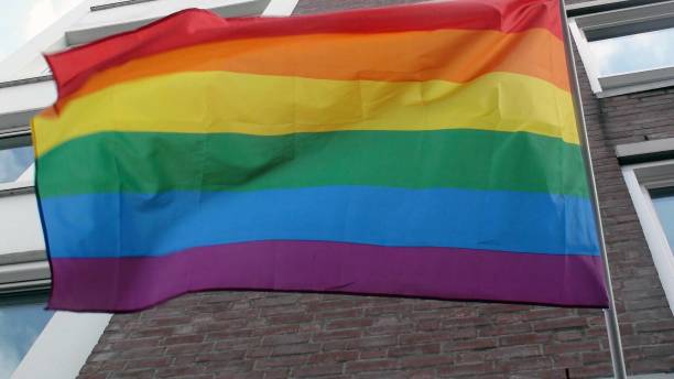 istock Rainbow Flag Hanging On Building Scene In The Netherlands 1172996232