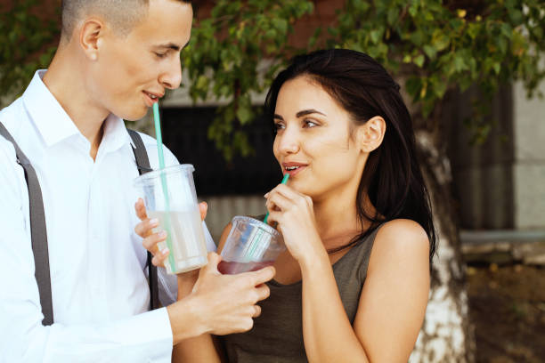 istock Young couple laughing and drinking cocktails 1172996893