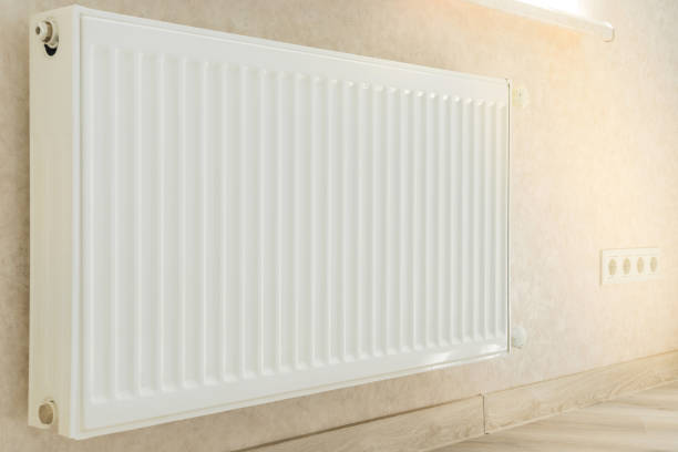 istock Individual heating radiator on a wall at an apartment. 1172997958