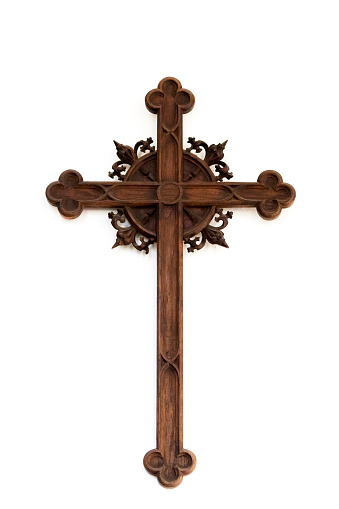 Old wooden cross on white background with copy space, vertical composition