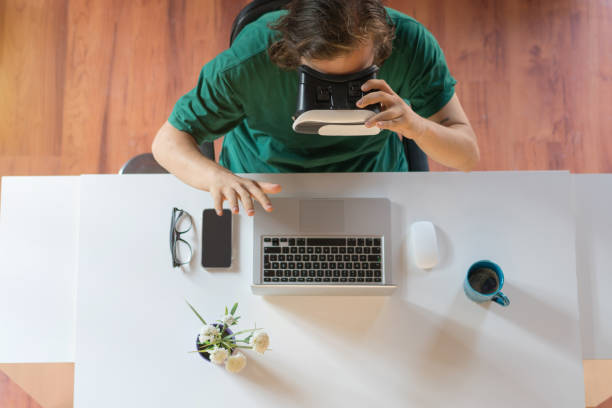 istock Young man wearing virtual reality headset at the office 1172998452